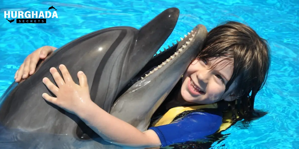 Child hugging dolphin