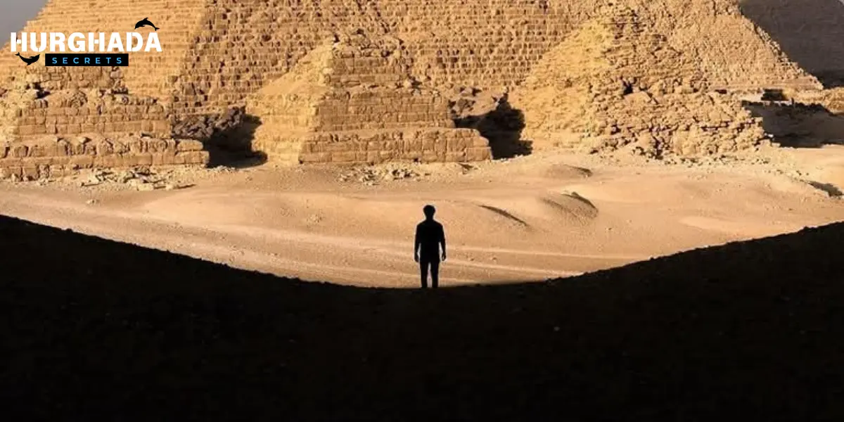 A man  in front of the pyramids