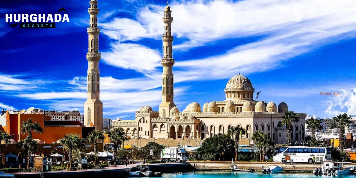 Sunny daytime view of El Mina Mosque with palm trees and fountain in Hurghada