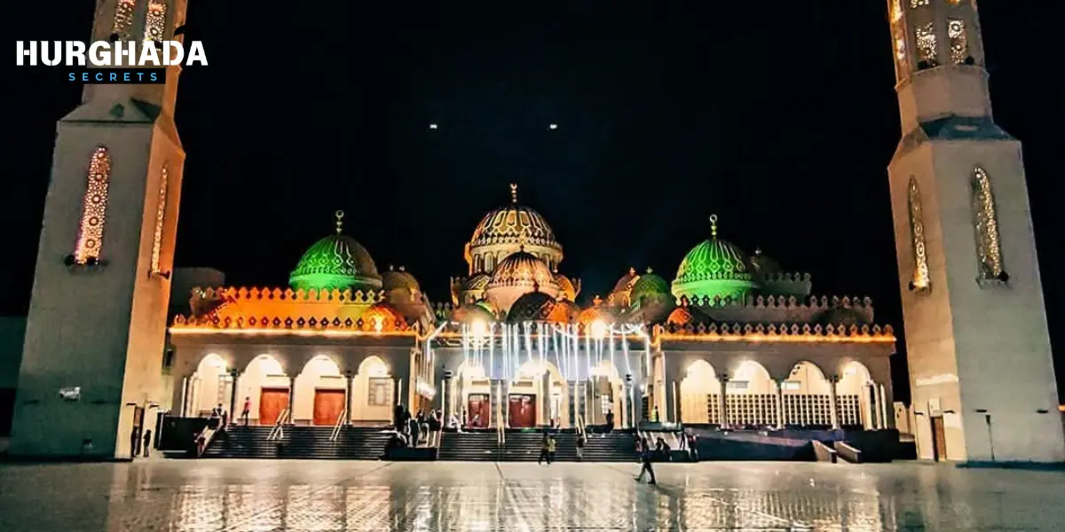 Night view of El Mina Mosque with green and orange lights in Hurghada